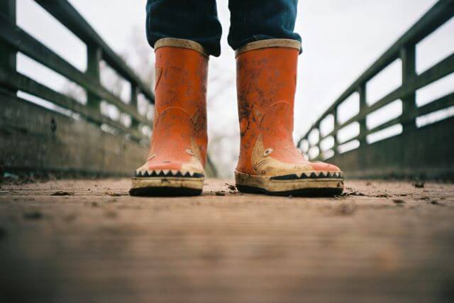 Child-sized orange muddy boots