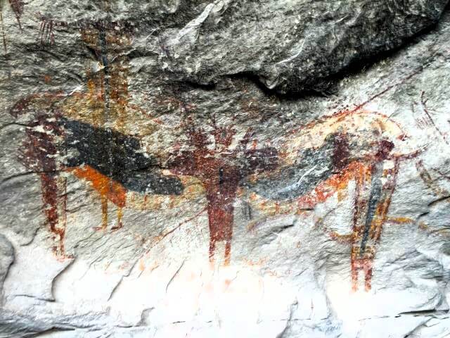 colorful paintings on a rock wall