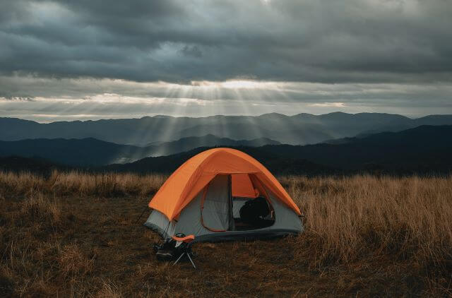 orange tent with sunlight beaming down on it