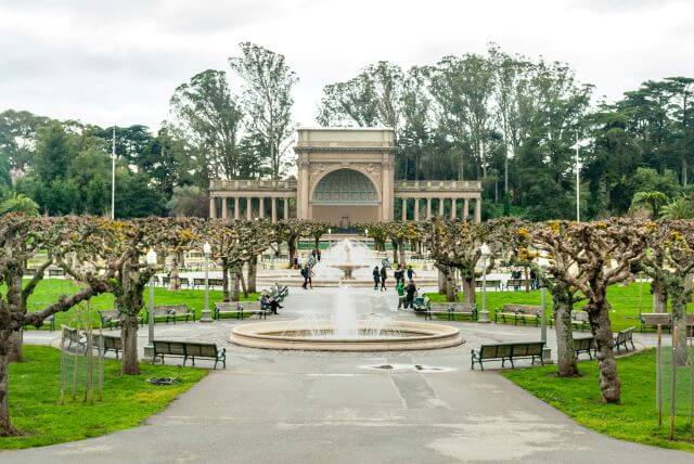 historic building with fountain and trees