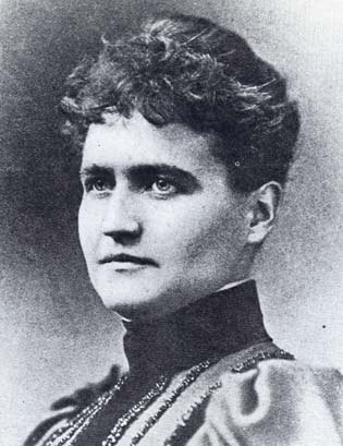 a black and white photo of a woman in historic dress