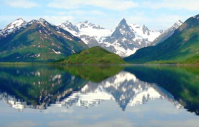snow-capped mountains reflected in a clear lake