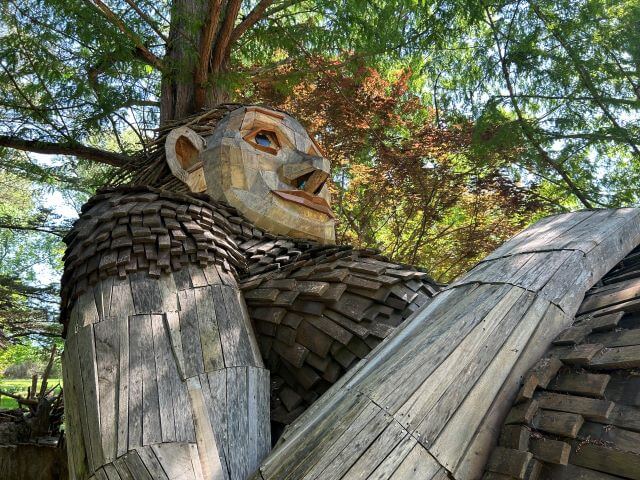 a wooden sculpture of a reclining woman