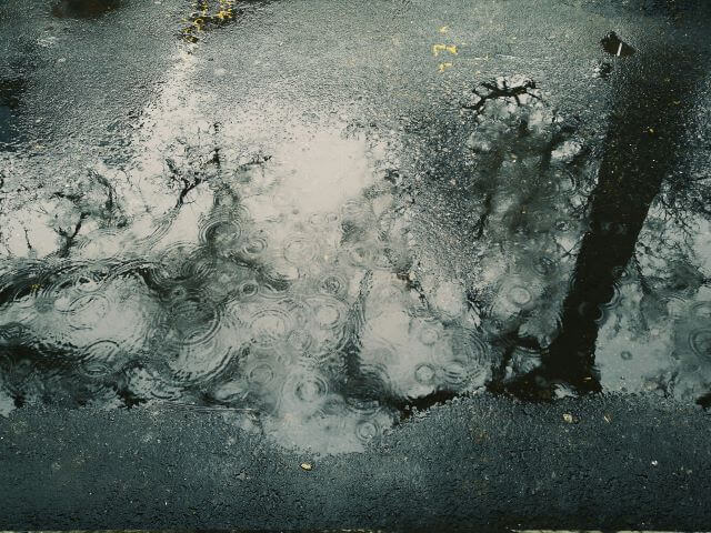 a pool of rain on pavement