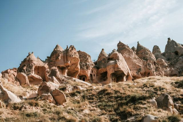 large rock formations with carved doors