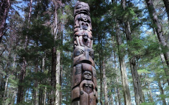 carved wooden pole in the forest
