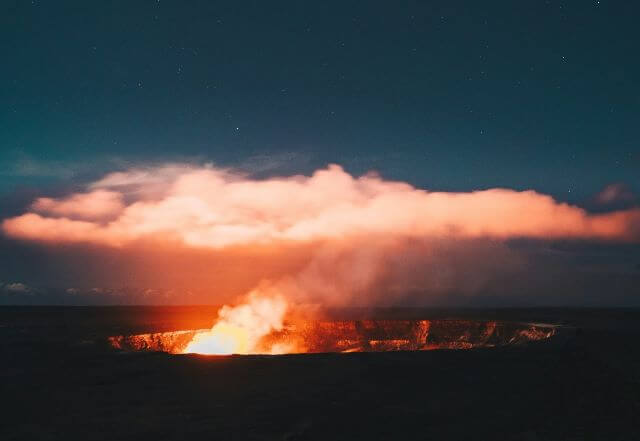 a fiery volcanic eruption at night