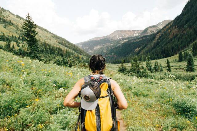hiker carrying a backpack outside