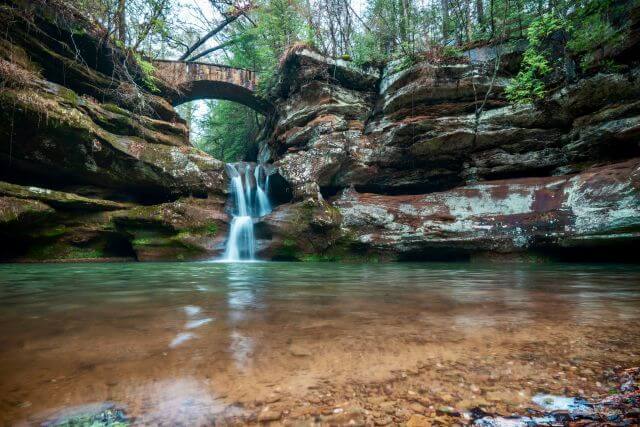 stone bridge over a small waterfall