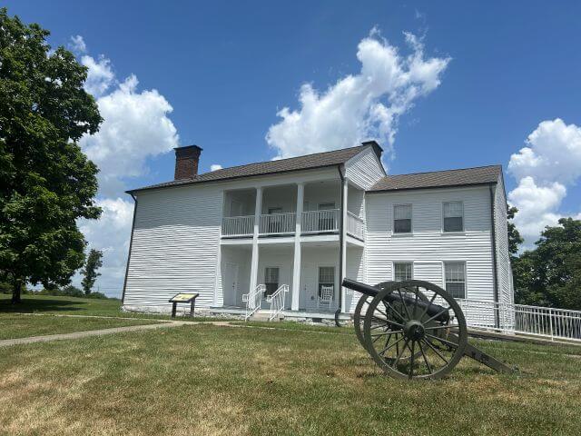 an historic white house with an American civil war canon out front
