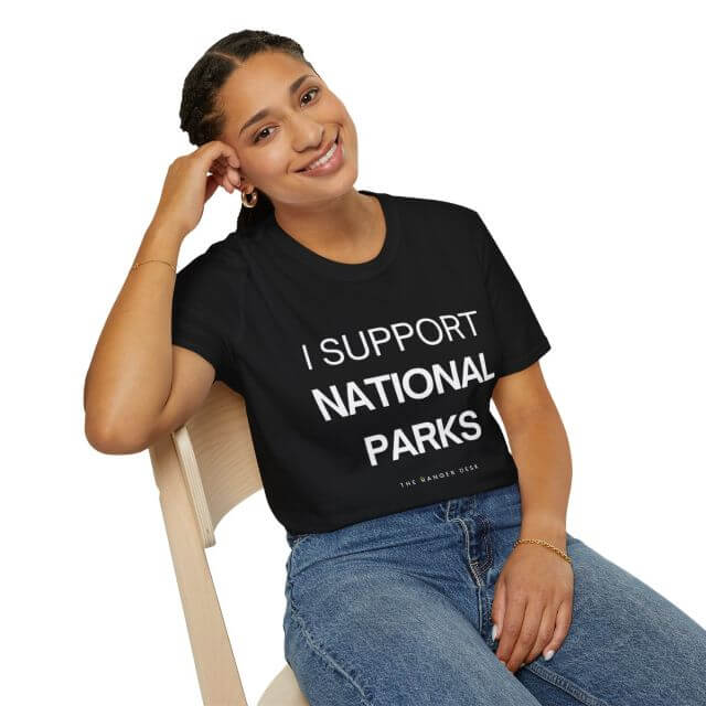 Seated person wearing I support national parks tee