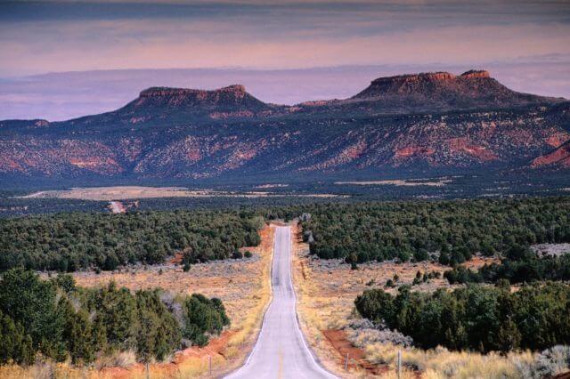 two flat top buttes on either side of a road